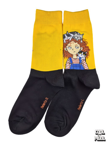 Cute curly-haired girl wearing dungarees with sleeping cats on her head woven crew socks made of bright yellow and black cotton fabric.
